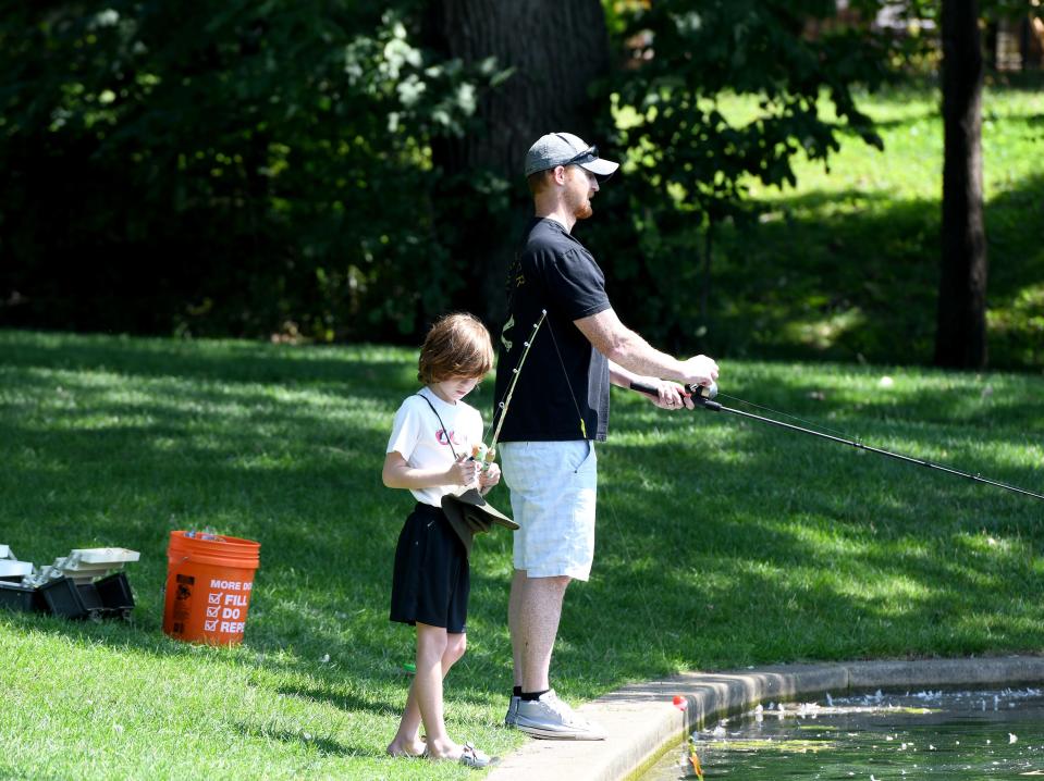 Jonathan Friske, 8, and his dad, Jon Friske of North Canton, spend time fishing at Price Park in North Canton on a sunny day.