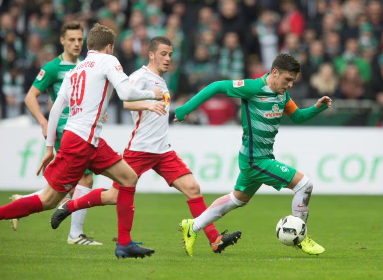 (L-R) Bremen's midfielder Robert Bauer, Leipzig's defender Benno Schmitz, Leipzig's midfielder Diego Demme and Bremen's midfielder Zlatko Junuzovic vie for the ball during the German First division Bundesliga football match March 18, 2017