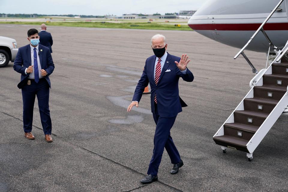 Democratic presidential candidate and former Vice President Joe Biden steps off a plane at Tampa International Airport in Tampa, Fla., on a visit for campaign events on Sept. 15, 2020. Stories circulating online incorrectly assert a video of Biden deplaning here shows him waving to an empty field. An Associated Press reporter traveling with Biden on Tuesday confirmed he was waving to firefighters and other ground personnel outside the frame of the video.