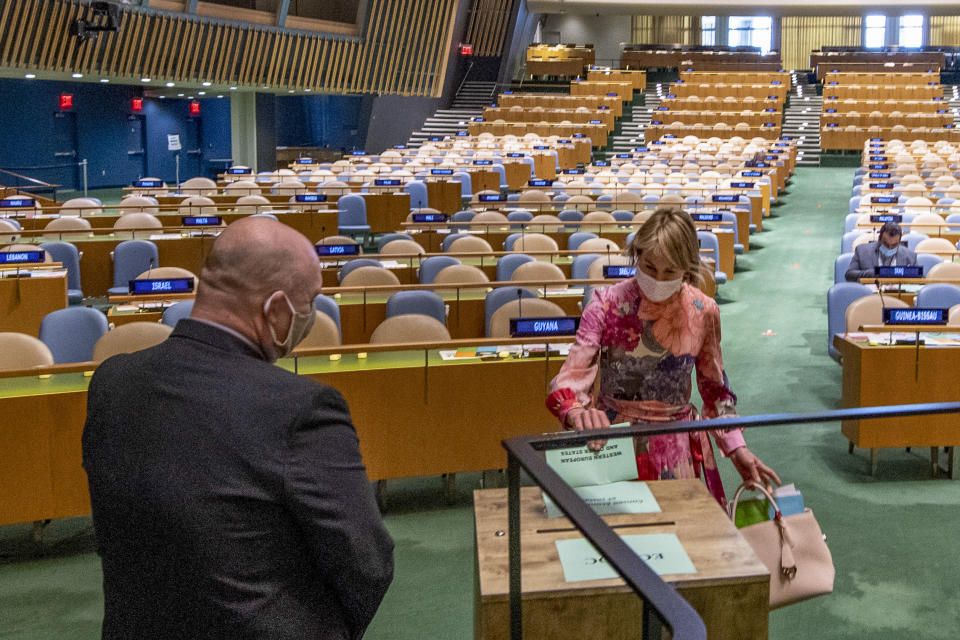 United States ambassador to the United Nations, Kelly Craft, right, casts a vote during U.N. elections, Wednesday, June 17, 2020, at U.N. headquarters in New York. Norway and Ireland won contested seats on the powerful U.N. Security Council Wednesday in a series of U.N. elections held under dramatically different voting procedures because of the COVID-19 pandemic. (Eskinder Debebe/UN Photo via AP)