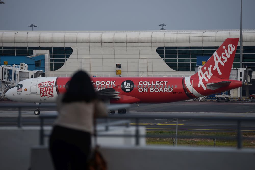 An AirAsia plane is pictured on the tarmac of the Kuala Lumpur International Airport in Sepang August 20, 2019. — Picture by Miera Zulyana