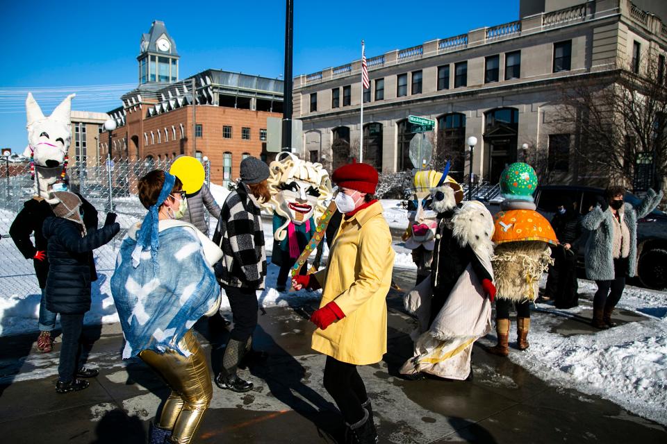 Joy Marchers pause for a dance party on the corner of Linn and Washington Streets in Iowa City on Saturday. The Joy March takes place every three months, and the colorful show welcomes all participants. The next one is scheduled for April 2.