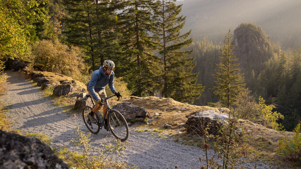 Man riding gravel bike on a misty track