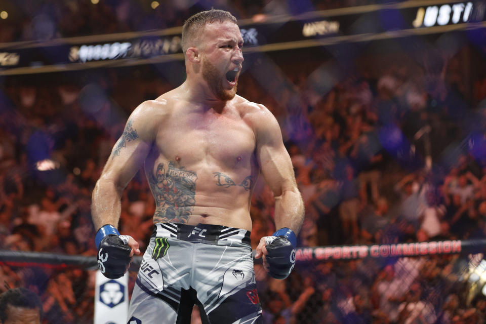 July 29, 2023;  Salt Lake City, Utah, USA;  Justin Gaethje (blue gloves) reacts to defeating Dustin Poirier (red gloves) during UFC 291 at the Delta Center.  Mandatory credit: Jeff Swinger-USA TODAY Sports