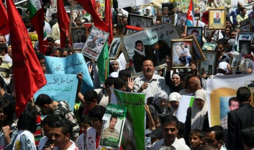 Palestinians hold pictures of incarcerated relatives during a rally in the West Bank city of Nablus, May 8, in solidarity with prisoners on hunger strike. UN chief Ban Ki-moon urged Israel to try or release hunger-striking Palestinian prisoners after activists denounced his "silence" in a protest outside the UN's West Bank offices