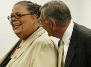 Chicago Teachers Union President Karen Lewis, left, is greeted by Chicago Board of Education President David Vitale at a Chicago Board of Education meeting on Wednesday, Aug. 22, 2012 in Chicago. The union has been locked in negotiations with the board, calling for fair contracts with higher pay for its teachers. (AP Photo/Sitthixay Ditthavong)