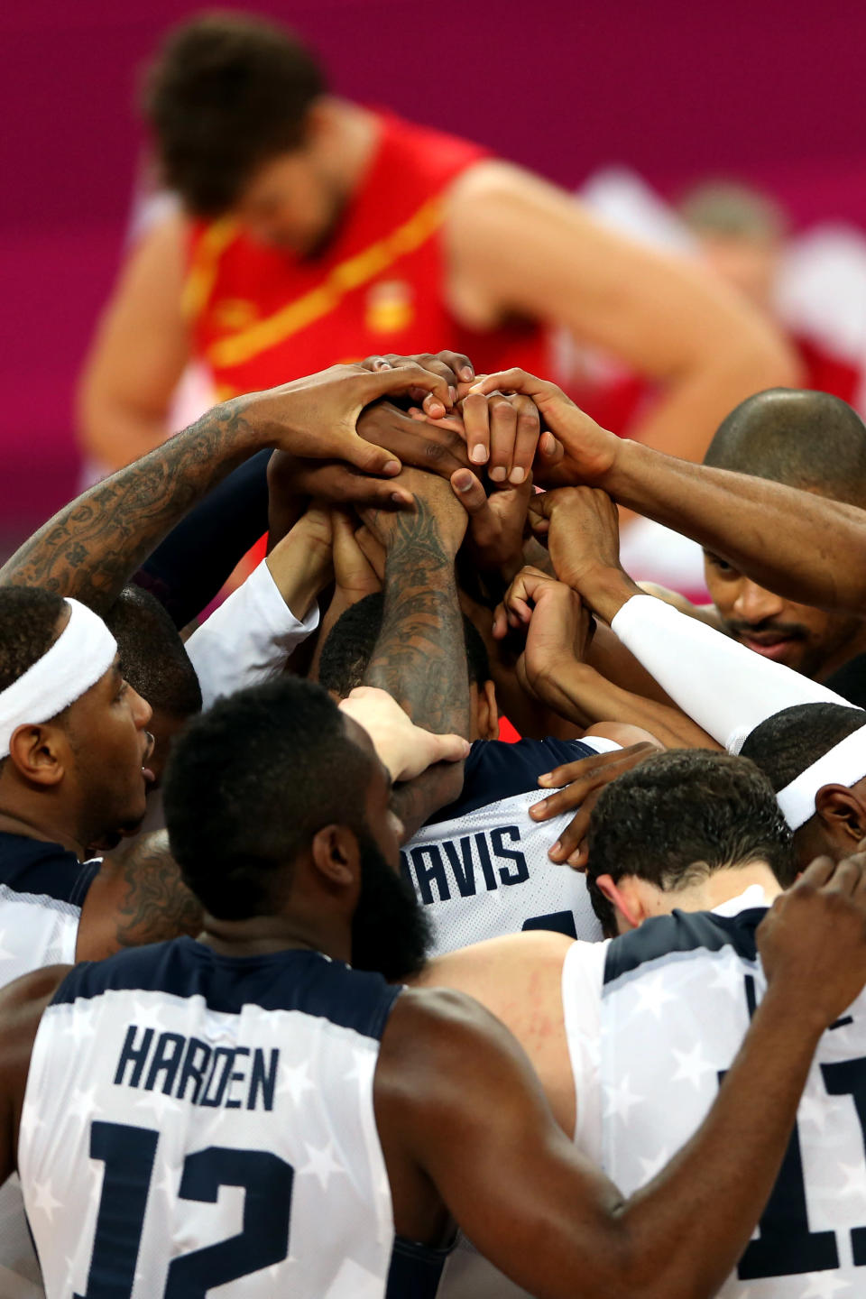 The United States players join hands as they celebrate winning the Men's Basketball gold medal game between the United States and Spain. (Getty Images)