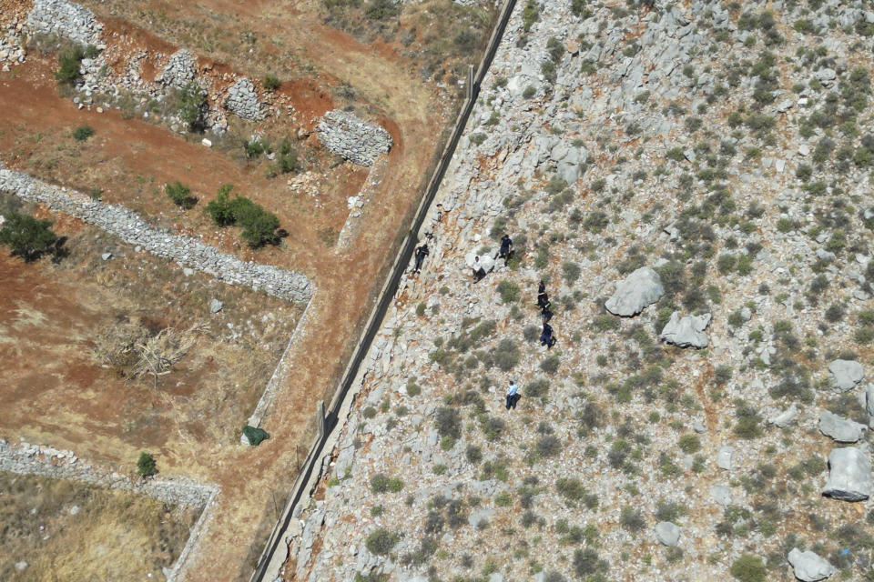 The body of missing British TV presenter Michael Mosley lies on a rocky area on the island of Symi, Sunday, June 9, 2024. The family of missing British TV presenter Dr. Michael Mosley have confirmed his body has been found on a Greek island. Mosley’s wife said Sunday in a statement that her husband had gone for a hike and took the wrong route and collapsed in a place where his body couldn’t easily be seen. (AP Photo/Panormitis Chatzigiannakis)