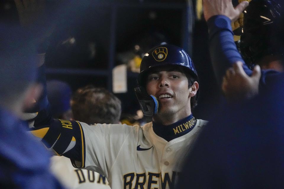 Milwaukee Brewers' Christian Yelich is congratulated after hitting a home run during the third inning of a baseball game against the Minnesota Twins Tuesday, April 2, 2024, in Milwaukee. (AP Photo/Morry Gash)
