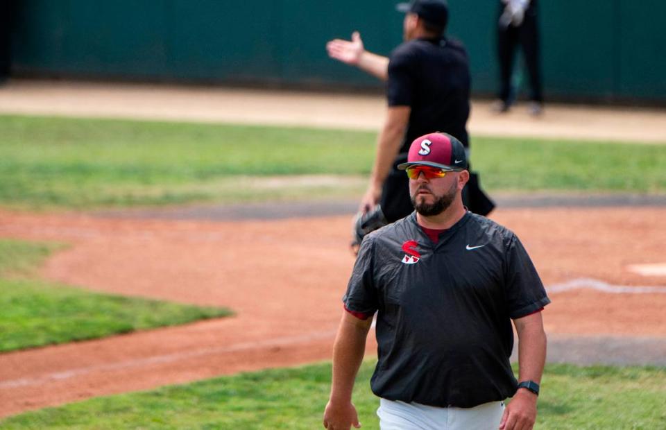 Sierra College coach Ryan Evangelho returns to the dugout after a discussion with the umpire during a game against Folsom Lake College in the California Community College Athletic Association state championship tournament on Sunday.