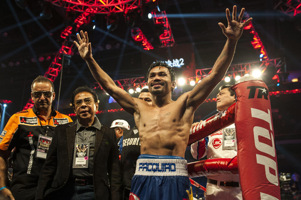 Manny Pacquiao celebrates his victory over Chris Algieri at the end of their world welterweight championship boxing bout in Macau on November 23, 2014 (AFP Photo/Xaume Olleros)