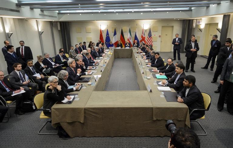 P5+1 European Union officials and Iranian officials wait for the start of a meeting on Iran's nuclear program at the Beau Rivage Palace Hotel in Lausanne on March 30, 2015