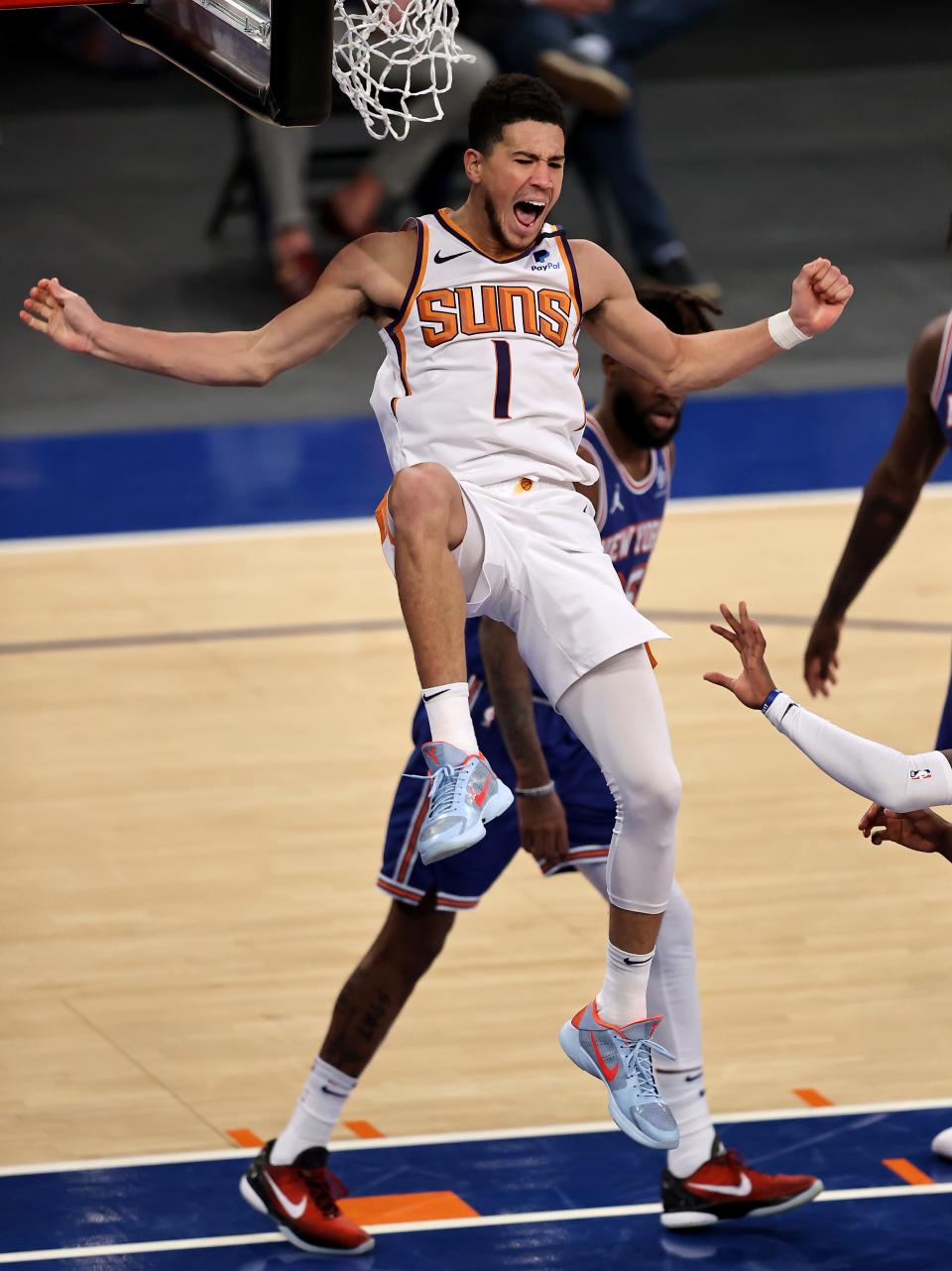 Apr 26, 2021; New York, New York, USA;  Devin Booker #1 of the Phoenix Suns celebrates his dunk in the third quarter against the New York Knicks at Madison Square Garden. Mandatory Credit:  Elsa/POOL PHOTOS-USA TODAY Sports