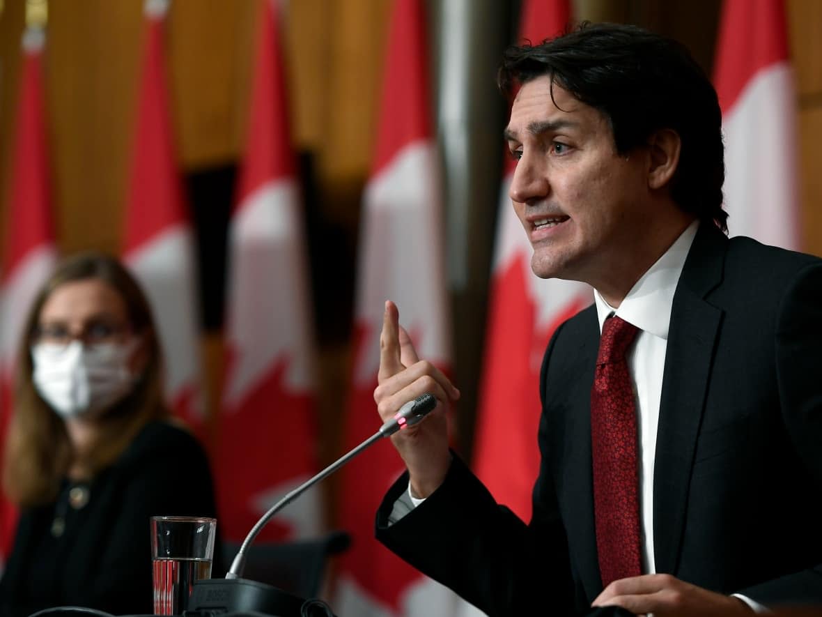 Minister of Families, Children and Social Development Karina Gould looks on as Prime Minister Justin Trudeau answers questions about Quebec's Bill 21. (Justin Tang/The Canadian Press - image credit)