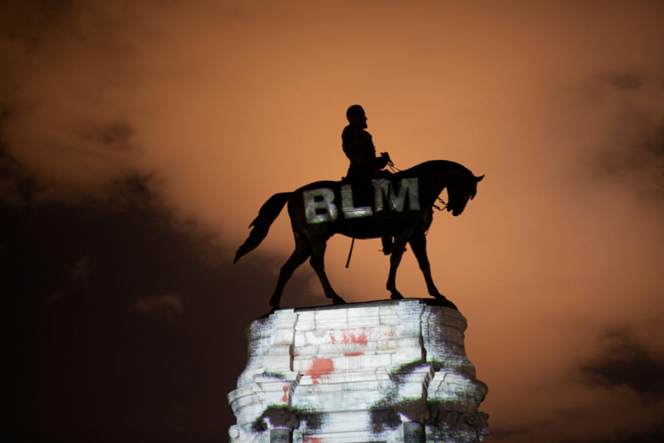 A Black Lives Matter image is projected onto a statue of Confederate Gen. Robert E. Lee