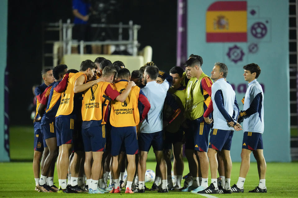 Spain head coach Luis Enrique, second from right, joins his team in a huddle before working out during a training session at Qatar University, in Doha, Qatar, Tuesday, Nov. 22, 2022. Spain will play its first match in Group E in the World Cup against Costa Rica on Nov. 23. (AP Photo/Julio Cortez)