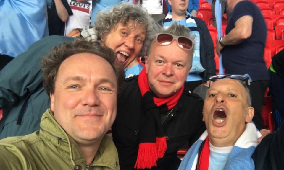 Simon Hattenstone (right) enjoying a football hug with fellow Manchester City fans.