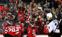 New Jersey Devils center Jack Hughes celebrates with New Jersey Devils left wing Tomas Tatar (90) after scoring a goal against the Arizona Coyotes during the first period of an NHL hockey game, Saturday, Nov. 12, 2022, in Newark, N.J. (AP Photo/Noah K. Murray)