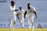 West Indies' Kyle Mayers celebrates taking the wicket of England's Craig Overton during day three of their third Test cricket match at the National Cricket Stadium in St. George, Grenada, Saturday, March 26, 2022. (AP Photo/Ricardo Mazalan)