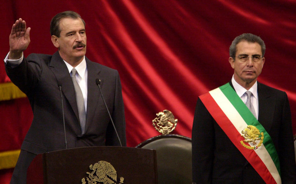 FILE - In this Friday Dec. 1, 2000 file photo, Mexican President-elect Vicente Fox, left, takes the oath of office as outgoing Mexican President Ernesto Zedillo listens during the inauguration ceremony at the National Congress in Mexico City. Mexicans hoped that their country would take a new course under Vicente Fox's center-right National Action Party, or PAN, but despite a more open economy and a bigger middle class, Mexico is torn by drug trafficking violence after a dozen years under the PAN's leadership, first under Fox and then under current President Felipe Calderon, who barely squeaked by in contested 2006 elections. (AP Photo/Dario Lopez-Mills, File)