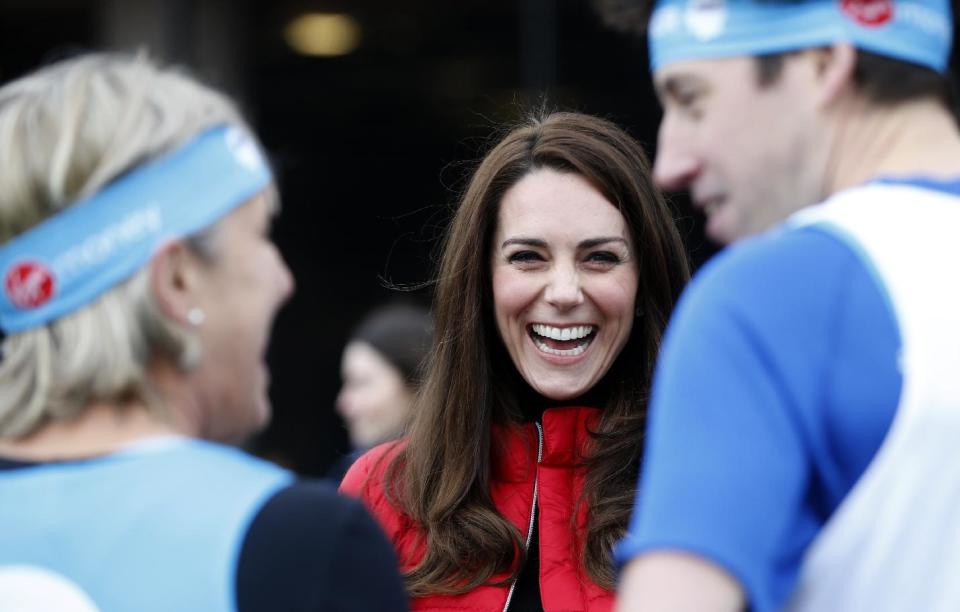 Britain's Kate, the Duchess of Cambridge, laughs as she prepares to take part in a relay race during a training event to promote the charity Heads Together, at the Queen Elizabeth II Park in London, Sunday, Feb. 5, 2017. (AP Photo/Alastair Grant, Pool)