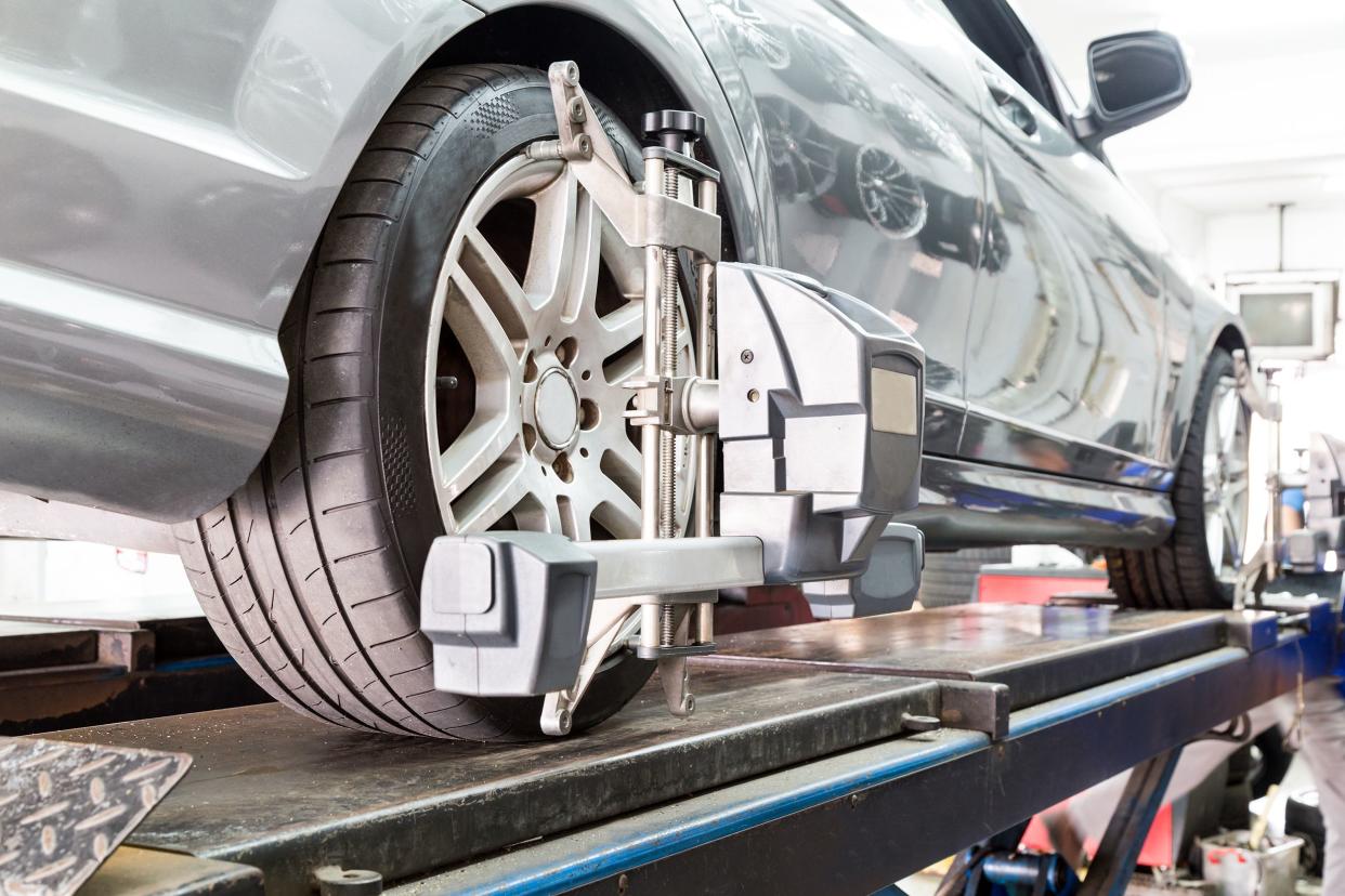 closeup of tire clamped with aligner undergoing auto wheel align