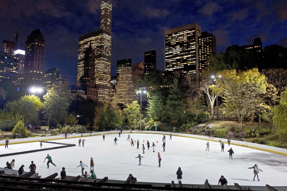 FILE - In this Nov. 3, 2016 file photo, skaters take to the ice at Wollman Rink in New York's Central Park. New York City will terminate business contracts with President Donald Trump after last week's insurrection at the U.S. Capitol, Mayor Bill de Blasio announced Wednesday, Jan. 13, 2021. The Trump Organization is under city contract to operate the two ice rinks and a carousel in Central Park as well as a golf course in the Bronx. (AP Photo/Mark Lennihan, File)