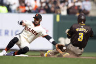 San Diego Padres' Jackson Merrill (3) slides safely into second base with a steal as San Francisco Giants second baseman Thairo Estrada (39) reaches for the errant relay during the ninth inning of a baseball game, Sunday, April 7, 2024, in San Francisco. (AP Photo/D. Ross Cameron)