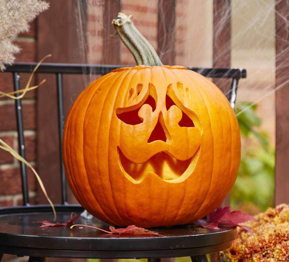 Orange pumpkin carved with a nervous face 