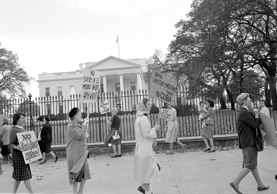 Women protesting the Cuban Missile Crisis demonstrate along the Pennsylvania Ave. sidewalk in front of the White House in Washington, D.C., Oct. 23, 1962.