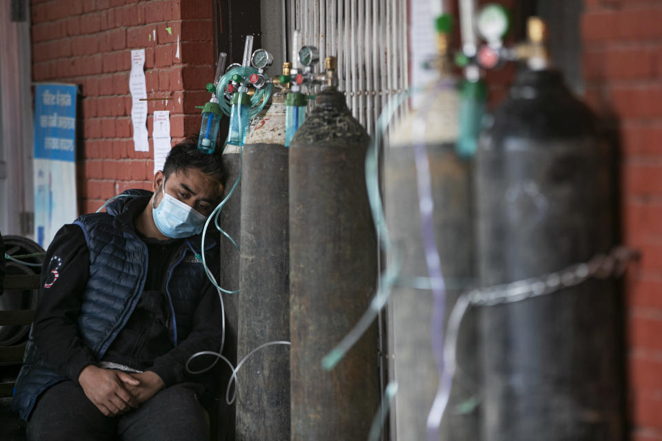 A COVID-19 patient receives oxygen outside an emergency ward at a government-run hospital in Kathmandu, Nepal, Thursday, May 13, 2021. (AP Photo/Niranjan Shrestha)