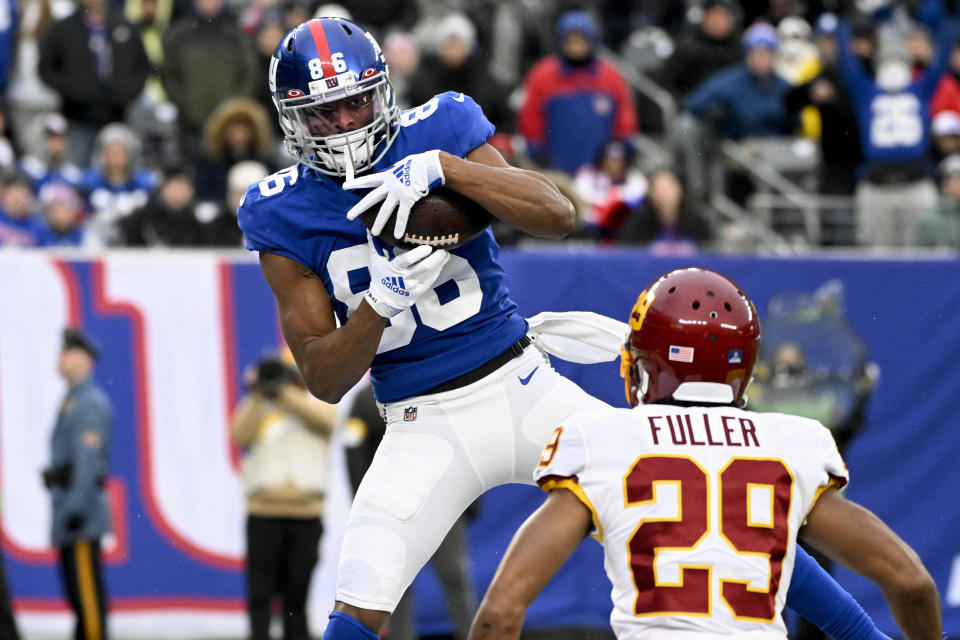 New York Giants wide receiver Darius Slayton (86) comes down with touchdown pass against Washington Football Team cornerback Kendall Fuller (29) during the fourth quarter of an NFL football game, Saturday, Jan. 9, 2021, in East Rutherford, N.J. (AP Photo/Bill Kostroun)