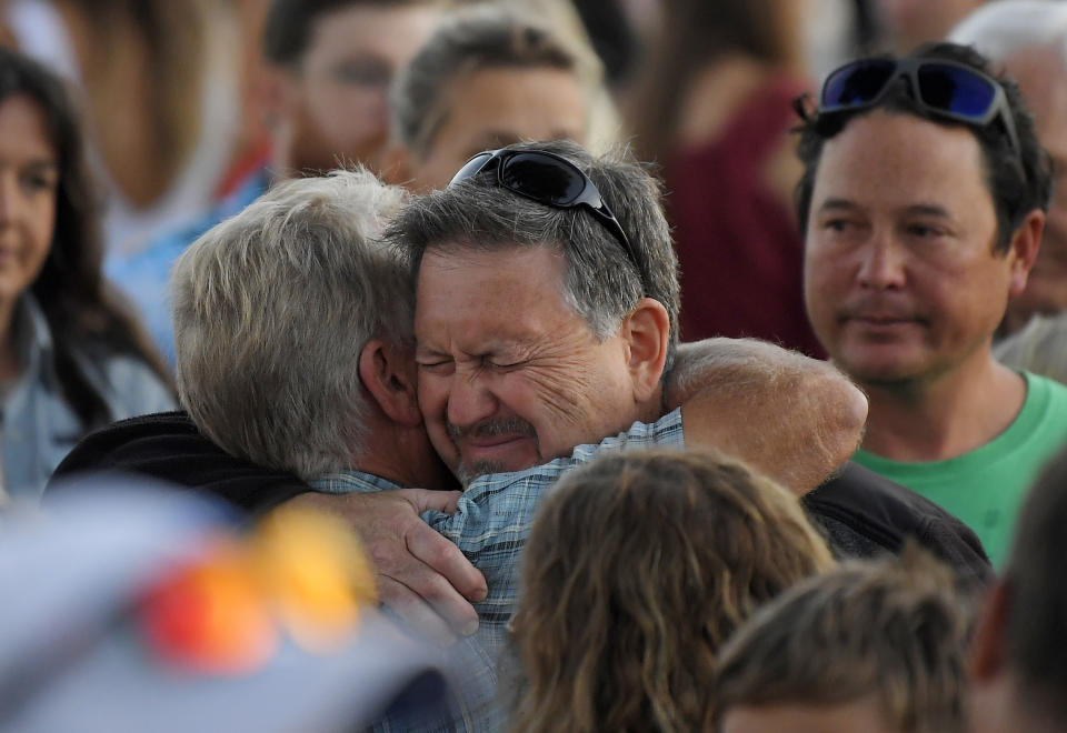 Glen Fritzler, left, co-owner of Truth Aquatics and the dive boat Conception, consoles an attendee during a vigil Friday, Sept. 6, 2019, in Santa Barbara, Calif., for the victims who died aboard the dive boat Conception. The Sept. 2 fire took the lives of 34 people on the ship off Santa Cruz Island off the Southern California coast near Santa Barbara. (AP Photo/Mark J. Terrill)