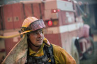 <p>CalFire firefighter Jake Hainey battles a wildfire near Oroville, Calif., on Saturday, July 8, 2017. The fire was one of more than a dozen burning in the state as firefighters worked in scorching temperatures to control unruly flames. (AP Photo/Noah Berger) </p>