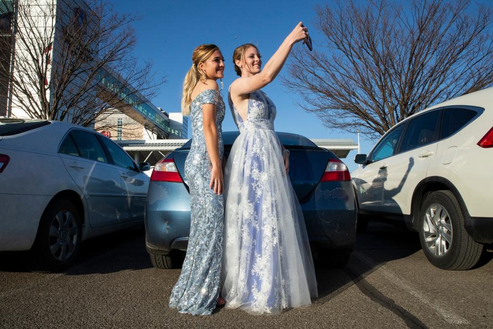 "This is my very first car and I worked all summer long to buy it," said Jocelyn Hoover, 18, at left, while taking a selfie by her car, with friend, Brittany Arndt, 20, on May, 7, 2022, before the start of the Fort LeBoeuf High School prom at the Bayfront Convention Center in Erie.