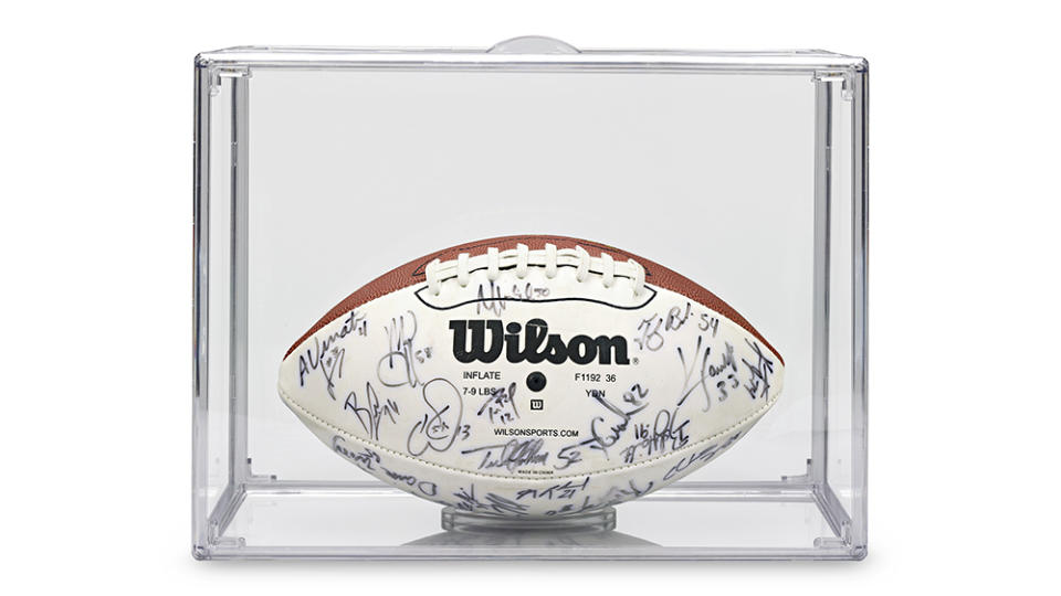 The Super Bowl XXXVI football signed by Tom Brady seen inside a protective case from M.S. Rau.