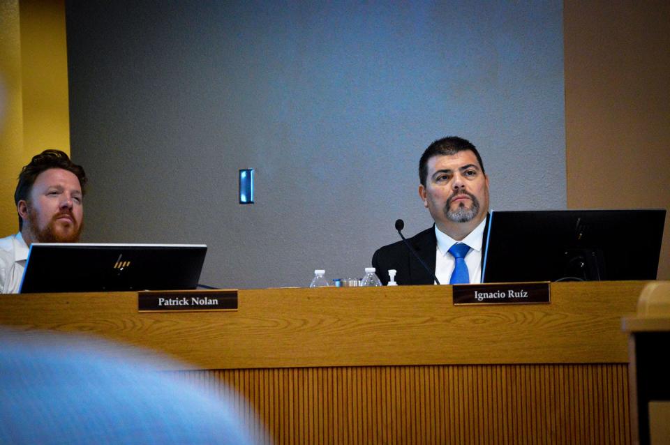 Board member Patrick Nolan, left, and Superintendent Ignacio Ruiz, right, listen to updates from presenters during an Aug.15, 2023,  school board meeting.