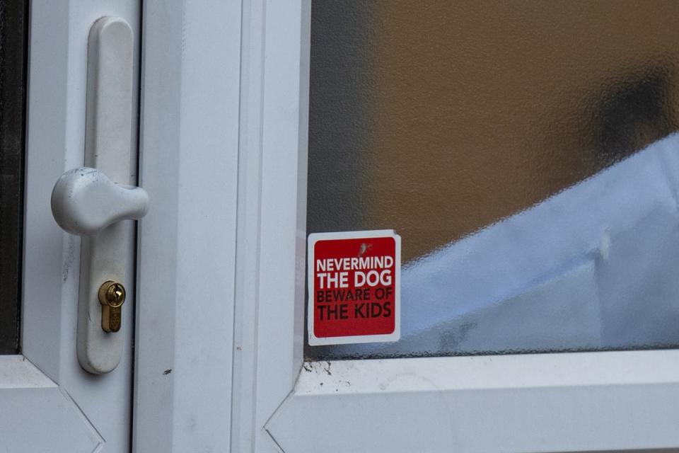 The sticker in a window next to the front door of the home where a woman was killed by her two dogs in Hornchurch (SWNS)