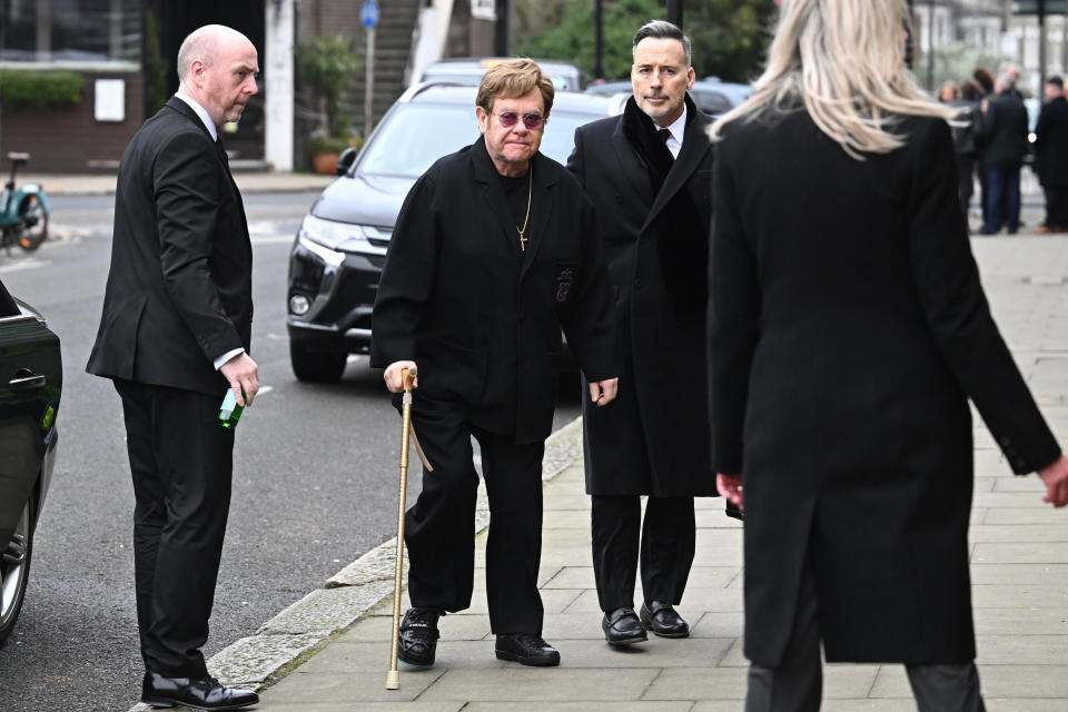 Elton John and David Furnish attend the funeral of Derek Draper. (Getty)