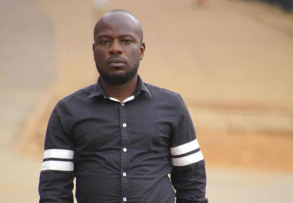 In this photo taken Friday Sept. 6, 2019, Albert Nabonibo, a well-known gospel singer in Rwanda, walks out from the Church of Zion temple celebration centre in Kigali, Rwanda. Nabonibo shocked many last month when he revealed he is a gay man in a country where such a public assertion of homosexuality is unheard of. (AP Photo/Olivier Muhizi)