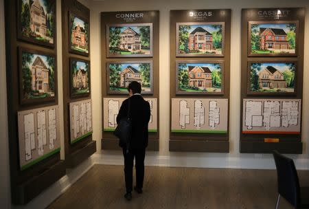 A woman views house designs at a showroom for Fieldgate Homes, one of three developers at the Impressions subdivision near the town of Kleinburg, Ontario, Canada May 13, 2017. REUTERS/Chris Helgren/Files