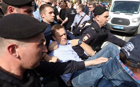 Opposition leader Alexei Navalny is detained at protests two days before Mr Putin's inauguration - Credit: TASS/Barcroft Images