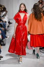 <p><i>Model wears a red patent-leather dress from the Calvin Klein SS18 collection. (Photo: IMAXtree) </i></p>