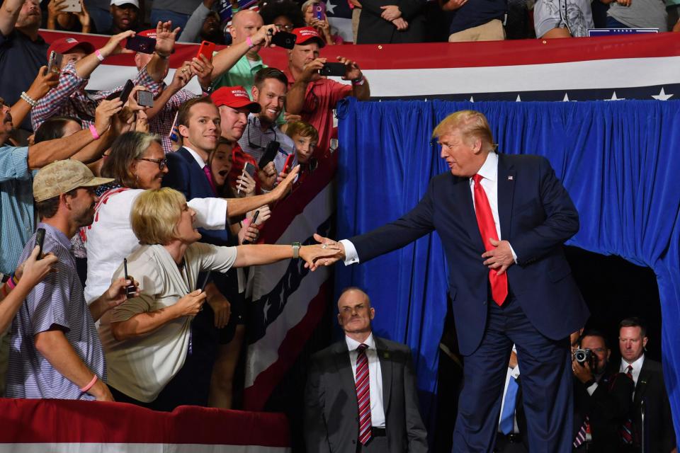 The president greets supports as he arrives at the rally (AFP/Getty Images)