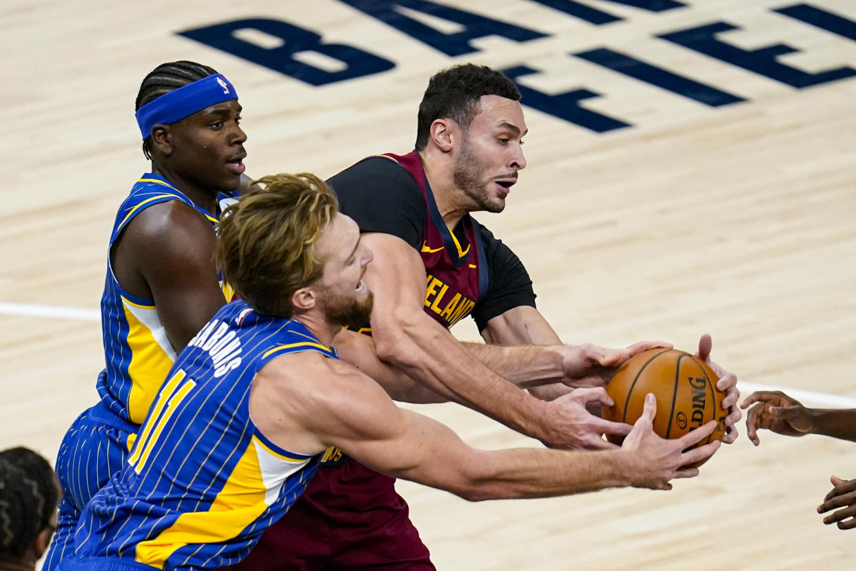 Indiana Pacers forward Domantas Sabonis (11) and Cleveland Cavaliers forward Larry Nance Jr. (22) fight for a long rebound during the first half of an NBA basketball game in Indianapolis, Thursday, Dec. 31, 2020. (AP Photo/Michael Conroy)