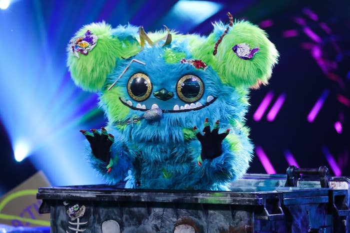 A furry blue and green bear character on "The Masked Singer"