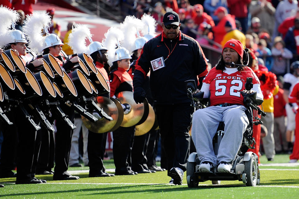 NEW BRUNSWICK, NJ - NOVEMBER 19: Eric LeGrand #52 of the Rutgers Scarlet Knights enters the stadium to be honored on Senior's Day at center field with head coach Greg Schiano of the Rutgers Scarlet Knights before a game against Cincinnati Bearcats at Rutgers Stadium on November 19, 2011 in New Brunswick, New Jersey. LeGrand was paralyzed during a kickoff return in October 2010. (Photo by Patrick McDermott/Getty Images)