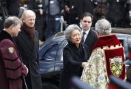 Canada's former Governor General Adrienne Clarkson (C) and her husband John Ralston Saul arrive for the state funeral of Canada's former finance minister Jim Flaherty in Toronto, April 16, 2014.