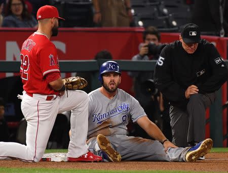 Jun 6, 2018; Anaheim, CA, USA; Los Angeles Angels third baseman Kaleb Cowart (22) and Kansas City Royals third baseman Mike Moustakas (8) wait for a review on a call in the eighth inning of the game at Angel Stadium of Anaheim. Mandatory Credit: Jayne Kamin-Oncea-USA TODAY Sports