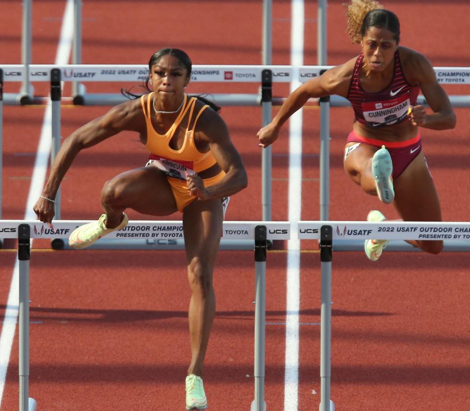 Alaysha Johnson, left, wins her heat of the women's 100 meter hurdles in day two of the USA Track and Field Championships 2022 at Hayward Field in Eugene Friday June 24, 2022.